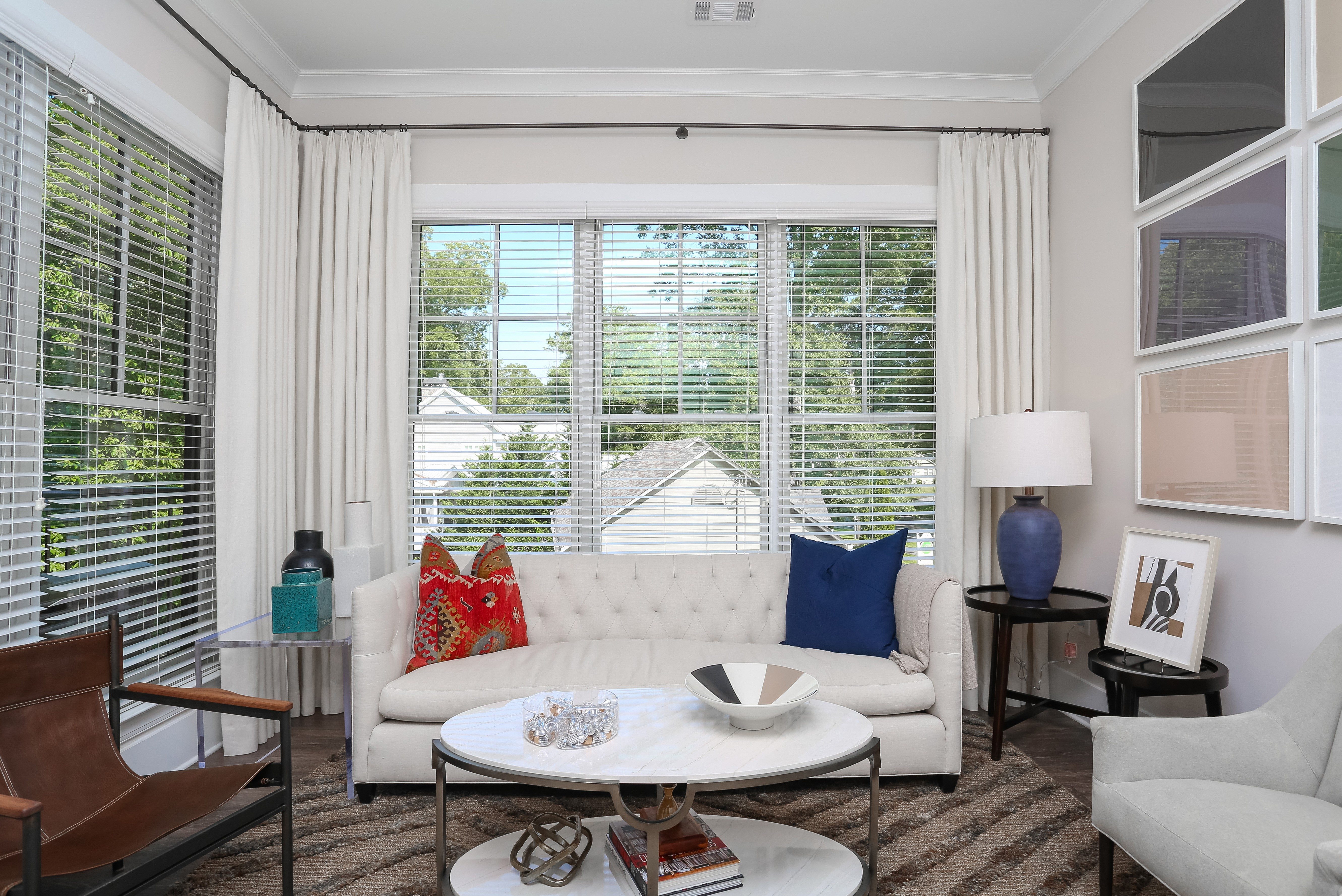 a living room with a white couch and a large window